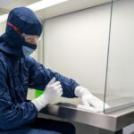 a person wearing a mask and gloves