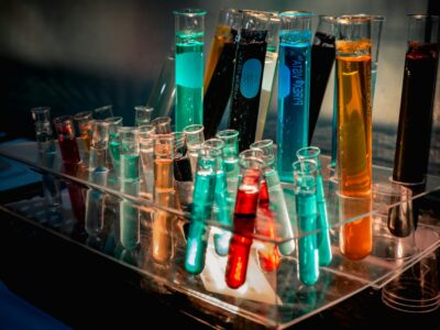 a bunch of test tubes filled with different colored liquids